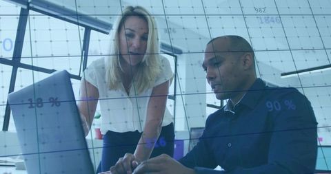 Professional Colleagues Analyzing Data Together in Modern Office