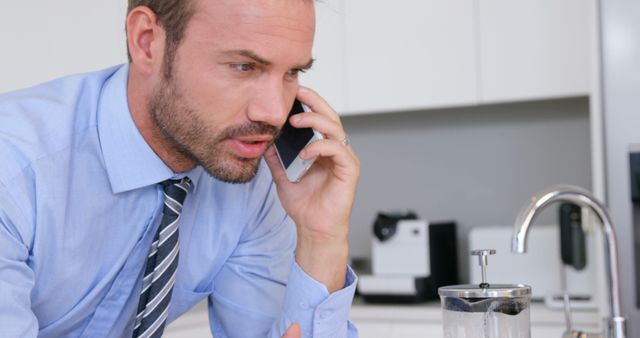 Businessman Talking on Smartphone During Coffee Break in Office Kitchen - Download Free Stock Images Pikwizard.com