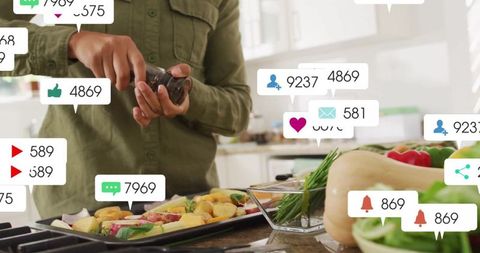 Social media engagement apparent around woman seasoning vegetables