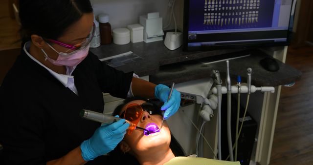 Dentist Using Ultraviolet Light on Patient for Dental Procedure - Download Free Stock Images Pikwizard.com