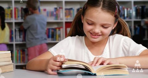 Young Girl Smiling While Reading Book in School Library