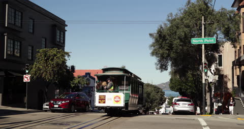Tram Descending City Hill with Passengers in Urban Setting