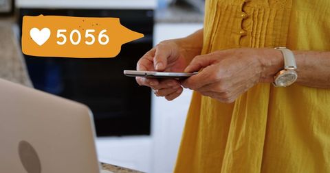 Woman Engaging Online with Smartphone Heart Icon Interaction