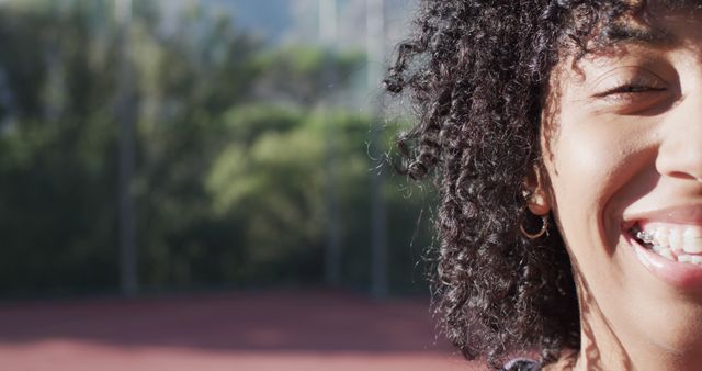 Close-up of Smiling Woman with Curly Hair Outdoors - Download Free Stock Images Pikwizard.com