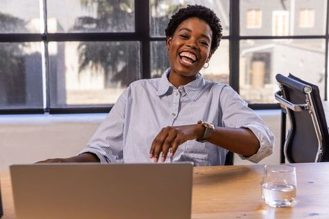 Laughing Professional Woman Enjoying Workplace Moments