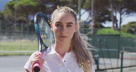 Female tennis player with racket on hardcourt looking focused