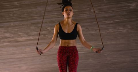 Young Woman Skipping Rope in Urban Environment Focused on Fitness