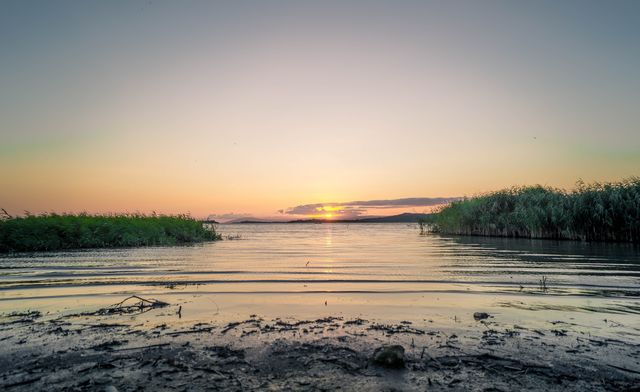 Tranquil Sunset Over Serene Lake With Clear Sky - Download Free Stock Photos Pikwizard.com