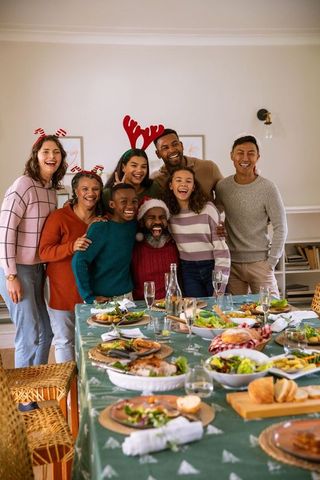 Happy family gathering celebrating holiday around festive table
