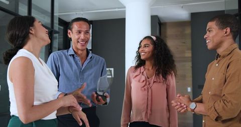 Colleagues Celebrating Successful Team Member in Office