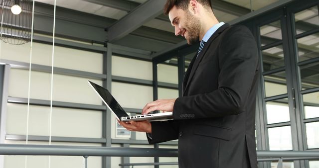 Confident Businessman Typing on Laptop in Modern Office - Download Free Stock Images Pikwizard.com