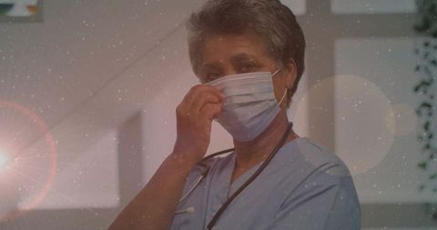Healthcare Professional Adjusting Medical Mask in Clinical Setting