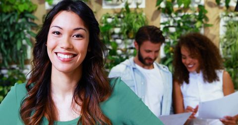 Smiling Businesswoman in Modern Office, Green Plant Background