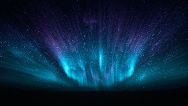 Teal violet aurora radiating over remote horizon, star streaks and motion blur curtains