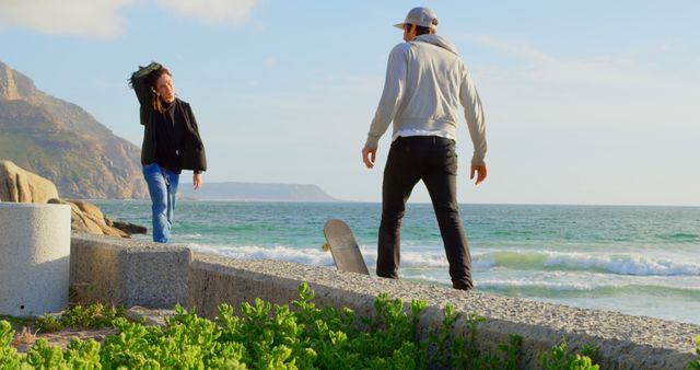 Father and daughter skateboarding near ocean during bright sunny day - Download Free Stock Images Pikwizard.com