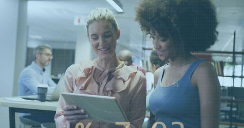 Businesswomen Collaborating with Digital Tablet in Modern Office - Download Free Stock Images Pikwizard.com