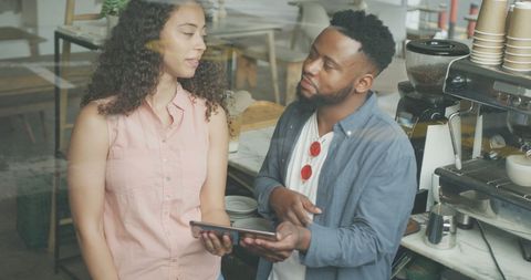 Cafe Manager Discussing Menu with Barista Colleague