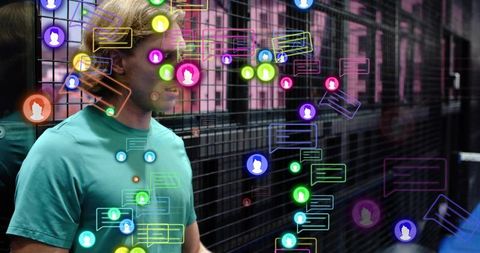Young man viewing augmented reality chat bubbles in exhibition corridor with neon overlays
