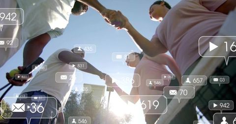 Friends joining hands on sunny tennis court showing teamwork with social media overlays