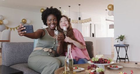 Joyful Couple Celebrating at Home with Champagne