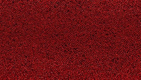 Shimmering glossy red beads texture with dense sparkle and specular highlights