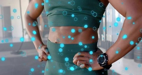 Closeup athletic woman showing toned torso in green activewear with smartwatch and ar overlay