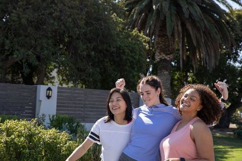 Diverse Female Friends Celebrating Post-Workout Outdoors