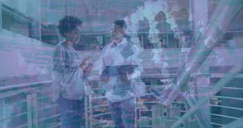 Engineers collaborating near robotic arms in futuristic lab