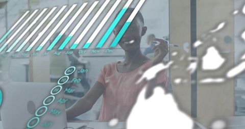 Smiling woman pointing at laptop with holographic data overlay showing monthly analytics