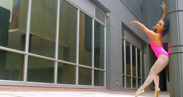 Ballet dancer in pink leotard performing on urban street - Download Free Stock Images Pikwizard.com