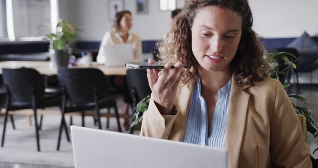 Businesswoman Using Smartphone for Voice Command in Office - Download Free Stock Images Pikwizard.com