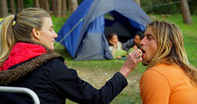 Friends Enjoying Camping in Forest Feeding Each Other - Download Free Stock Images Pikwizard.com