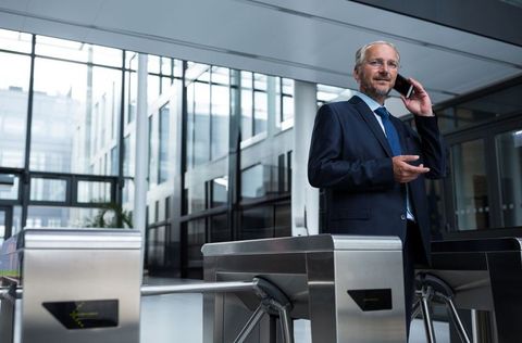 Business Executive Speaking on Smartphone in Modern Office Lobby