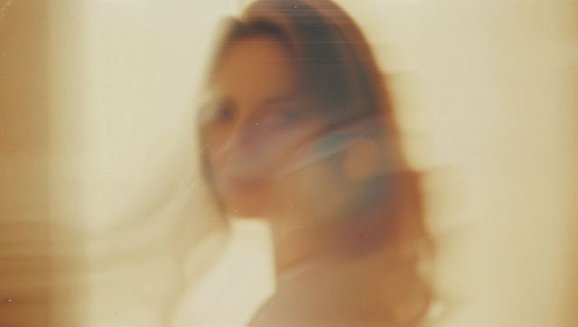 Elegant Woman with Flowing Hair in Dreamy Light