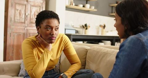 Two Friends Having a Heartfelt Conversation in Cozy Room