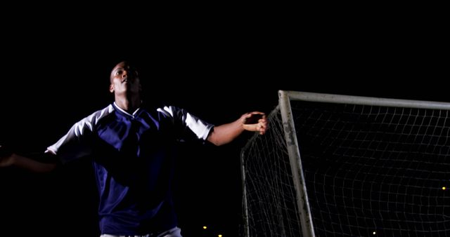 Soccer Player Celebrating After Scoring Goal Under Stadium Lights at Night - Download Free Stock Images Pikwizard.com