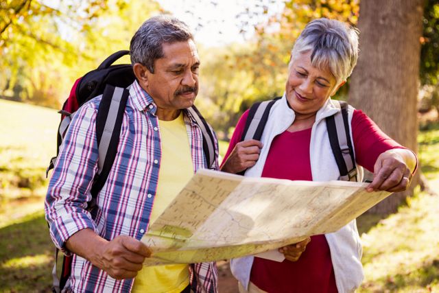 Mature couple looking a map in a park