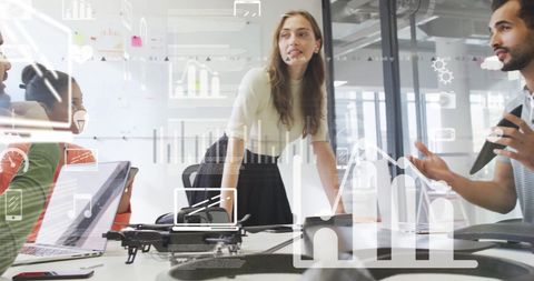 Diverse Team Collaborating on Digital Interface with Data Graphics Overlay