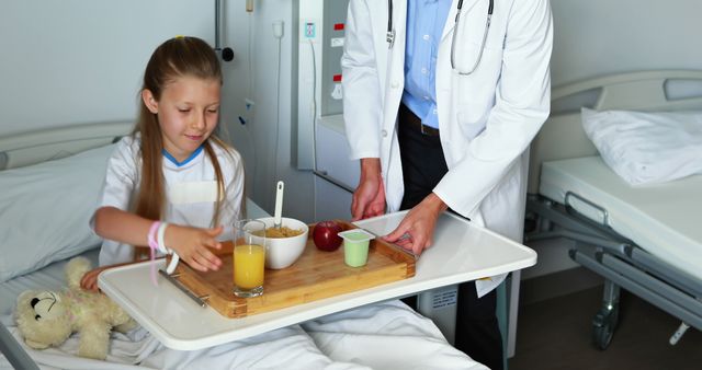 Doctor Serving Breakfast to Smiling Young Patient in Hospital Bed - Download Free Stock Images Pikwizard.com