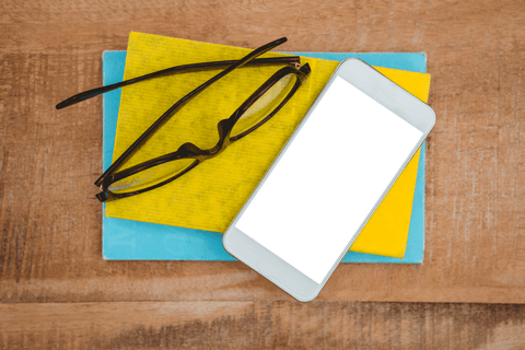 Transparent Smartphone with Glasses on Wood Surface