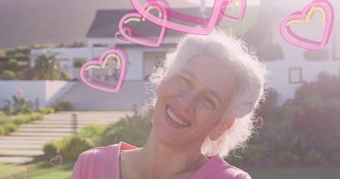 Smiling Senior Woman Radiates Joy Surrounded by Heart Icons