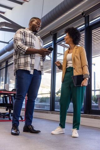 Diverse Coworkers Discussing Ideas in Modern Office