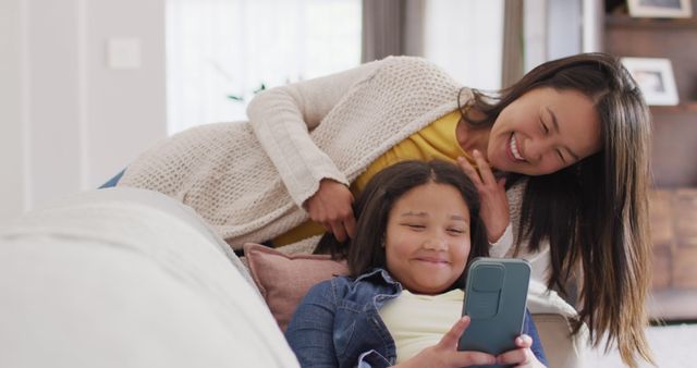 Mother and Daughter Relaxing on Couch and Using Smartphone - Download Free Stock Images Pikwizard.com