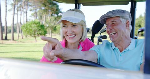 Senior golfers enjoying humorous moment on golf course together
