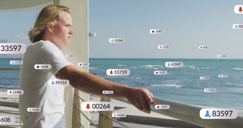 Man Observing Ocean with Digital Media Notifications