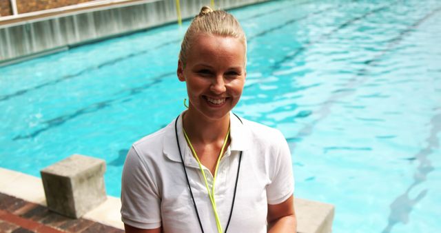 Female Lifeguard Smiling by Swimming Pool on Bright Day - Download Free Stock Images Pikwizard.com