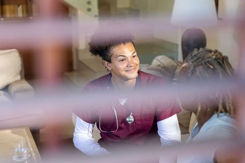 Home healthcare nurse making eye contact during compassionate in-home consultation