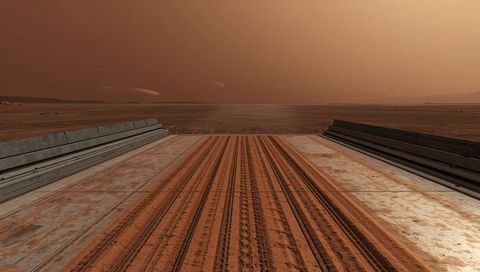 Rusting launch ramp extending into red desert plain with tire tracks and weathered rails