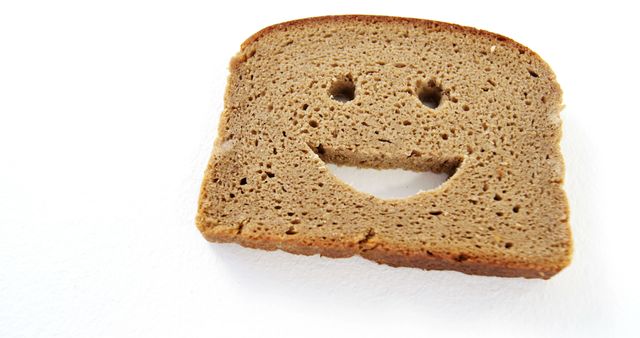 Smiley face on bread slice against white background