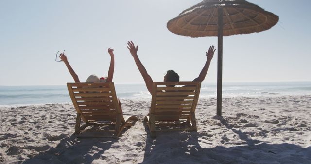 Couple Relaxing on Beach Loungers Under Straw Umbrella - Download Free Stock Photos Pikwizard.com